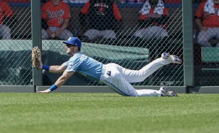 Jun 11, 2022; Kansas City, Missouri, USA; Kansas City Royals left fielder Andrew Benintendi (16) makes a diving catch against the Baltimore Orioles in the third inning at Kauffman Stadium. Mandatory Credit: Denny Medley-USA TODAY Sports